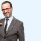 Teacher man using glasses proud, excited and arrogant, pointing with victory face isolated over blue background